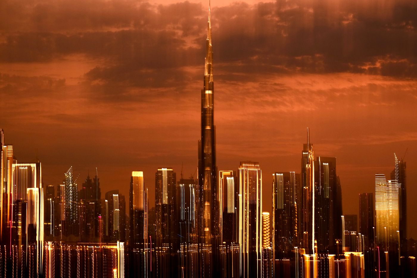 Dubai skyline and the Burj Khalifa illuminated at sunset