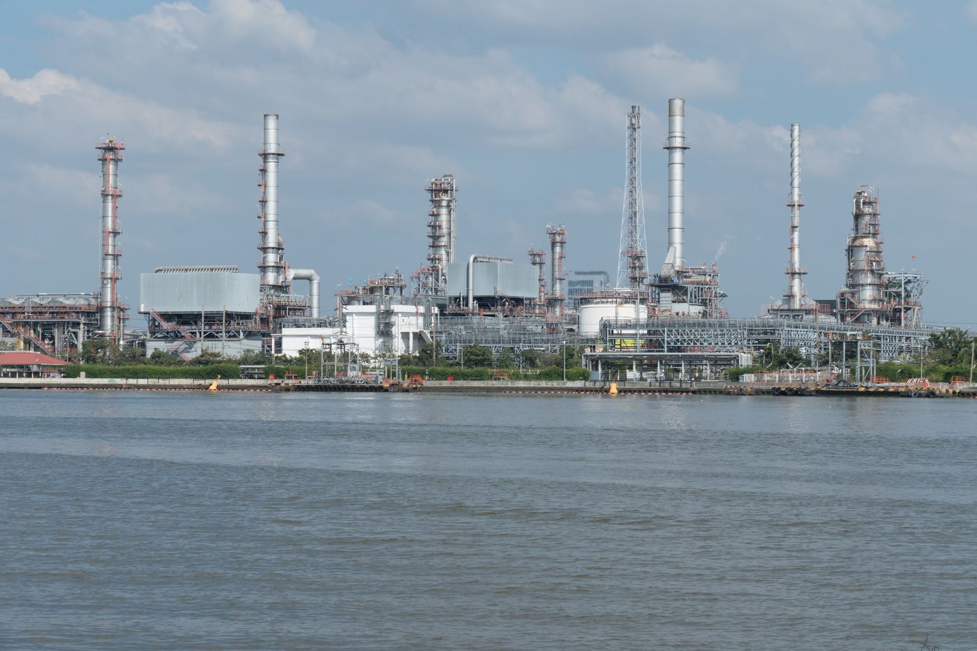 Processing towers and pipework at an oil refinery beside the water